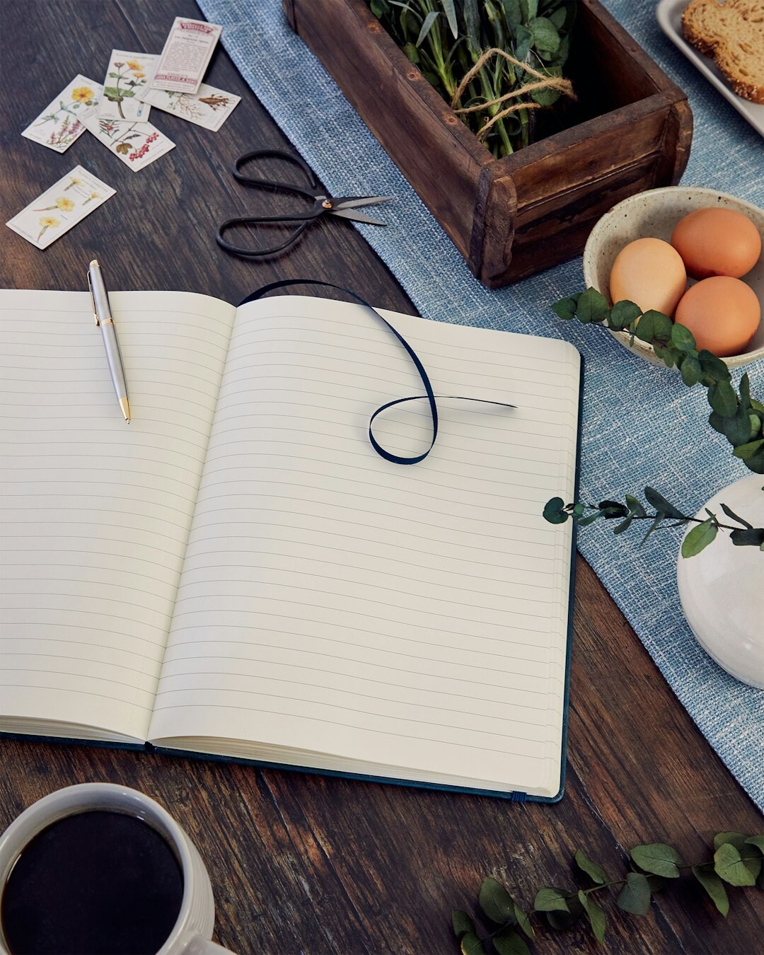 Open notebook with a handwritten recipe next to cooking ingredients